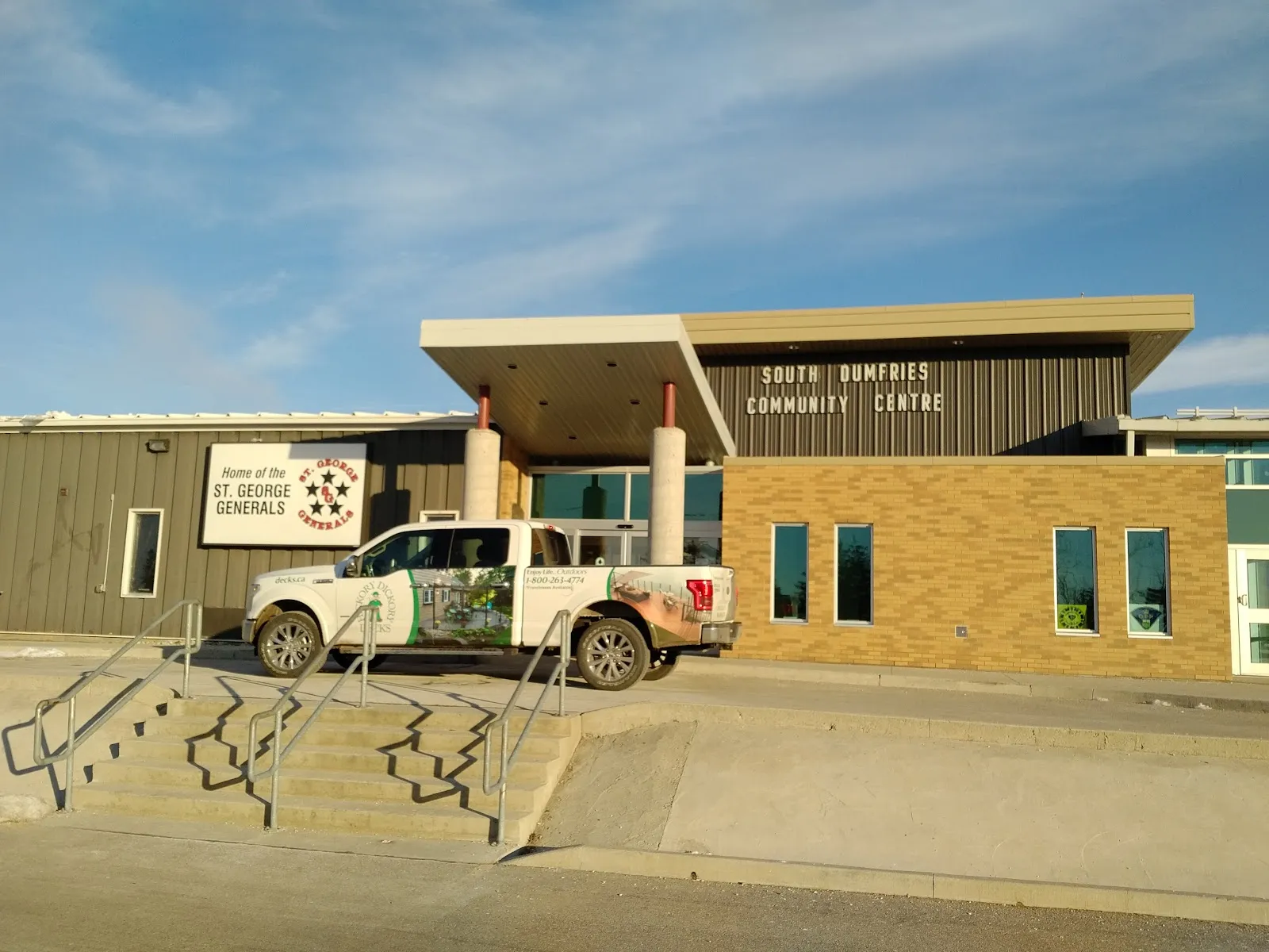 The brick-and-metal front of the community centre in St. George, with its covered entrance and steps and a St. George Generals sign beside the door. — Gaukel Memorial Community Centre