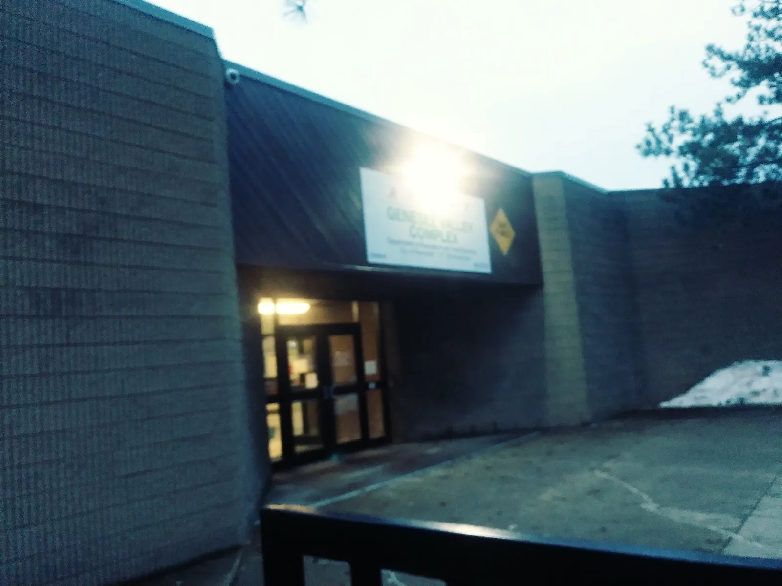 The lit entrance of the Genesee Valley Sports Complex, 131 Elmwood Ave — Genesee Valley Ice Rink