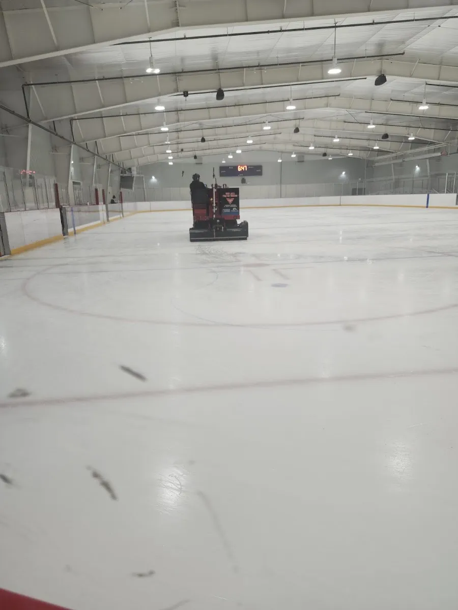 The Gill Street ice under the white roof with the resurfacer on the far half of the rink. — Gill Street Community Complex (Orillia)