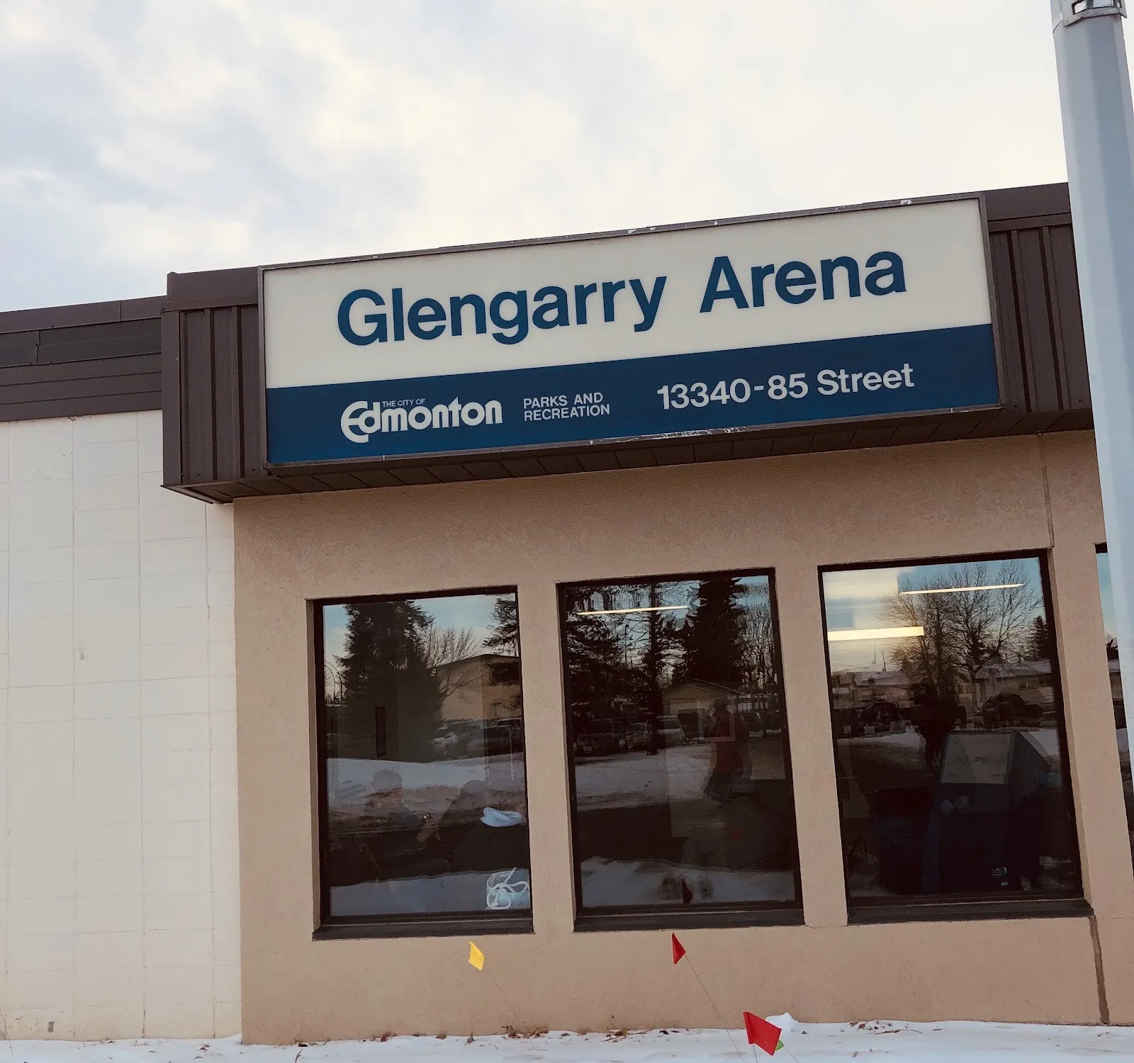 The front of the Glengarry Arena on 85 Street in Edmonton, under the City's Glengarry Arena sign in winter — Glengarry Arena