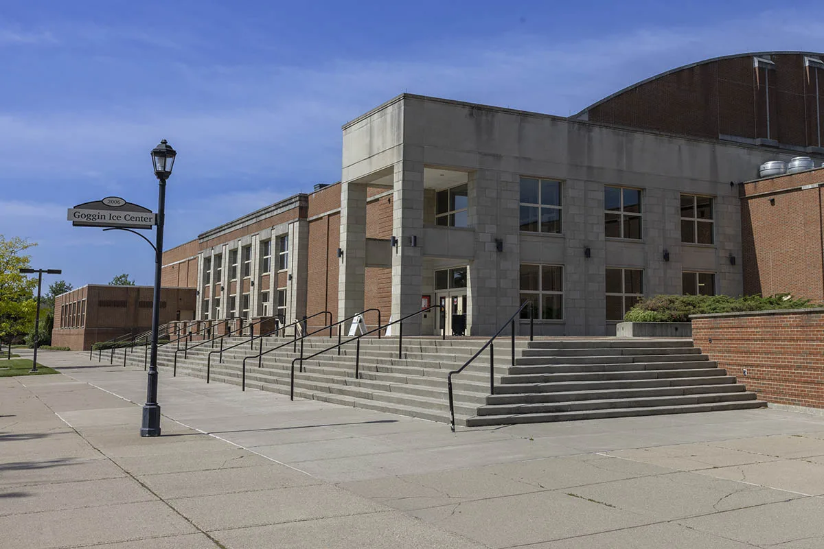 Main entrance of Goggin Ice Center on a clear blue-sky day — Goggin Ice Center