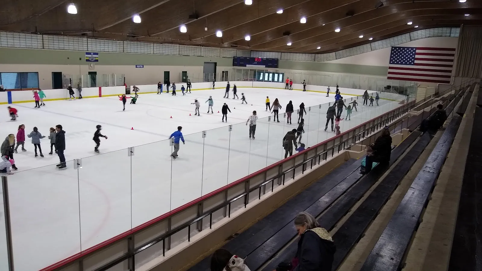 Skaters at a public session on the Greensfelder ice, seen from the bleachers — Greensfelder Recreation Complex Ice Rink