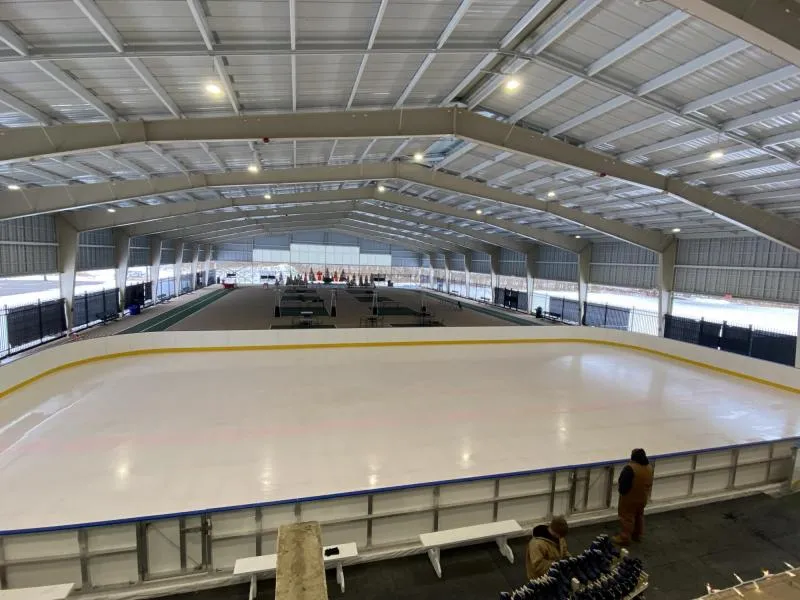 The ice sheet and boards inside the covered Grippen Community Park rink in Endicott, seen from the viewing area — Grippen Community Park Ice Rink