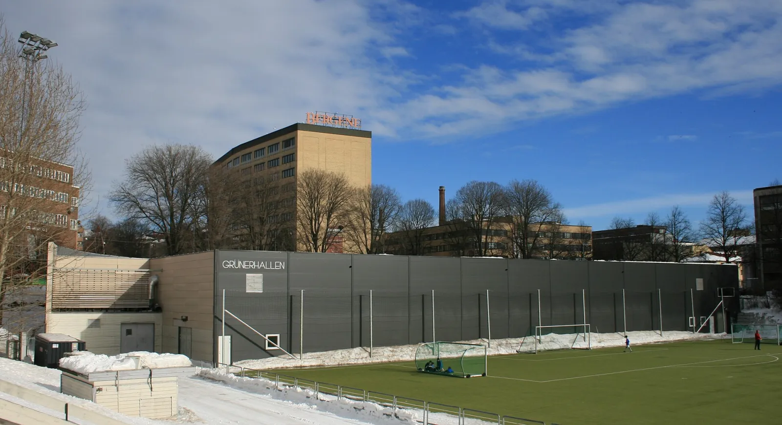 Grünerhallen seen from Dælenenga idrettspark, with the football pitch in front of the ice hall. — Grünerhallen