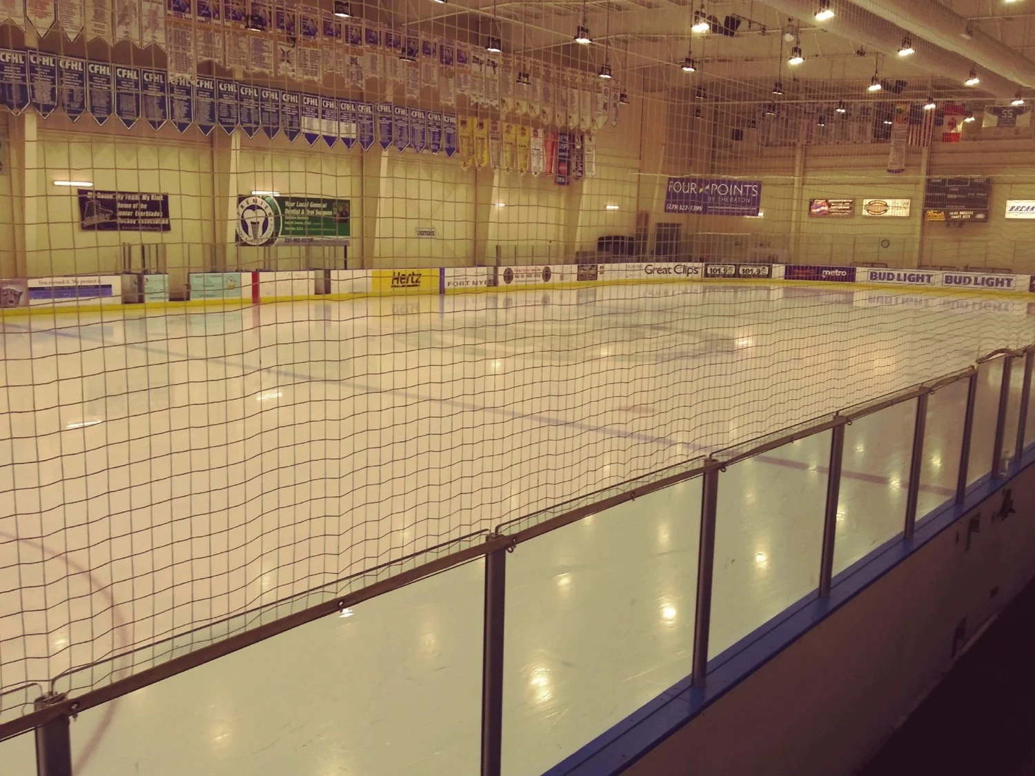 One of Hertz Arena's recreational ice sheets viewed through the spectator-side safety netting. — Hertz Arena