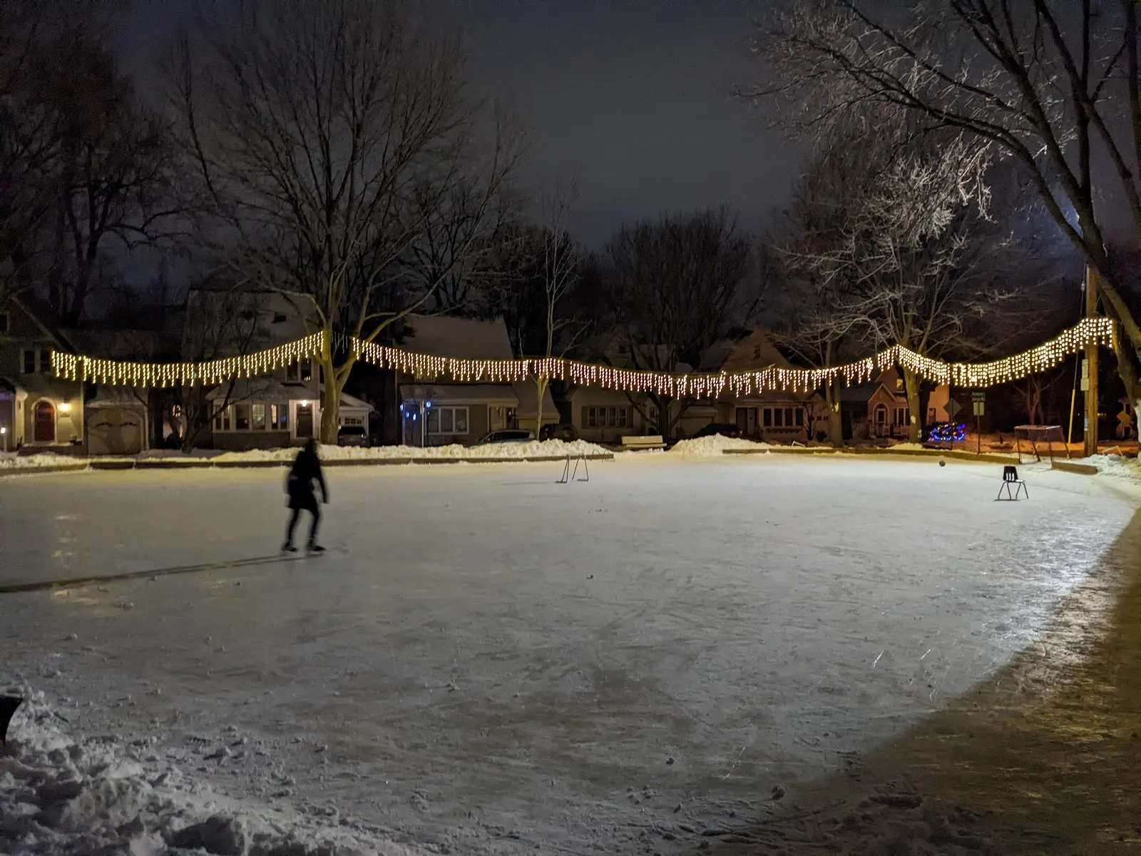 Skater on the lit Hillington Green Park rink at night, Madison (Google Maps listing photo) — Hillington Green Park Outdoor Rink