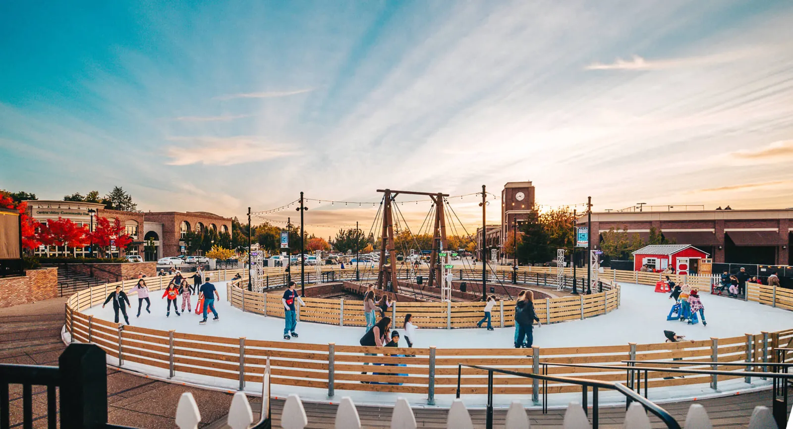 The Folsom Historic District ice rink at sunset with the district buildings behind — Historic Folsom Ice Rink