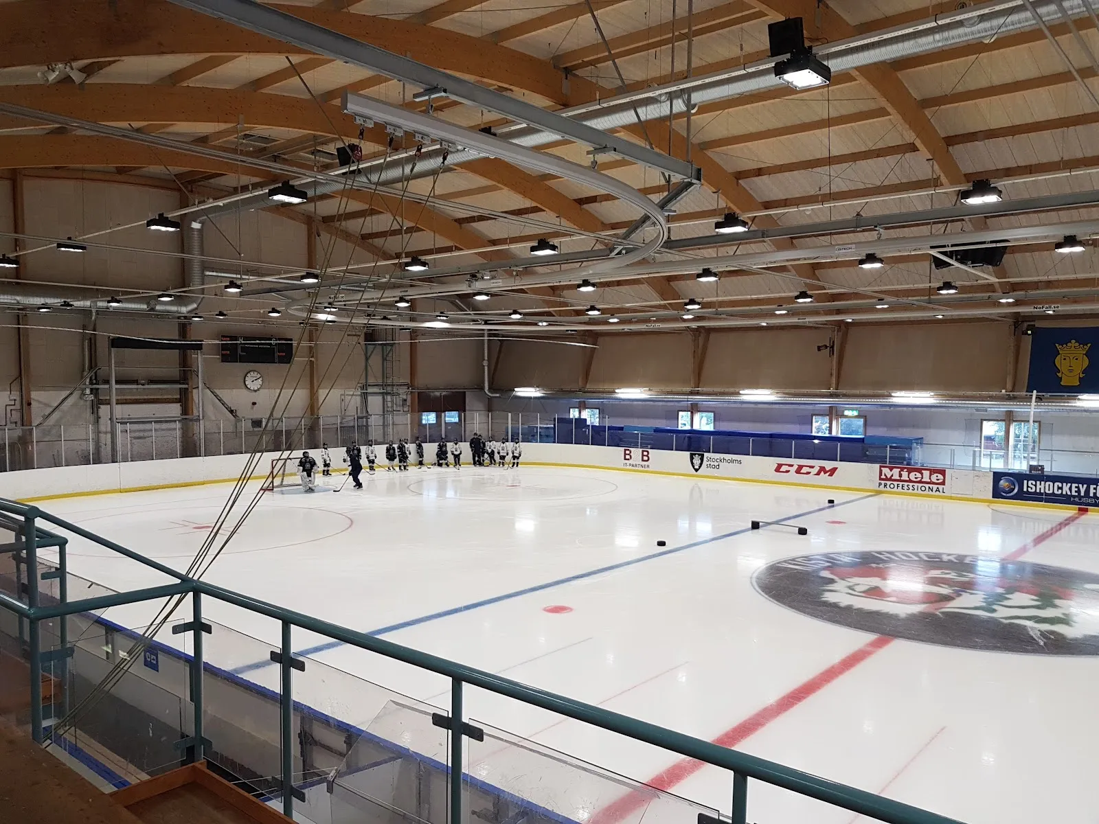 Ice of Husby ishall under its timber roof beams, seen from the stand — Husby ishall