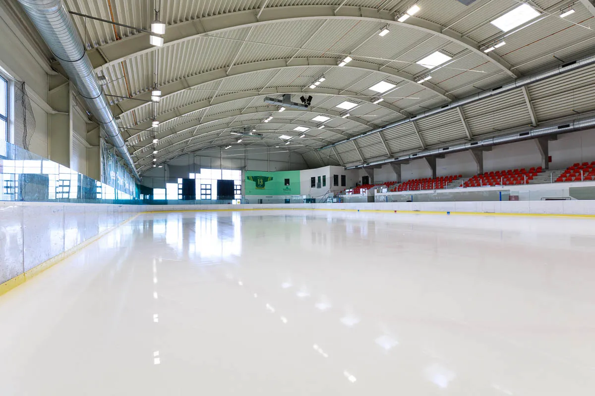 The empty ice sheet of the ICE ARENA Plzeň under the arched roof, seen from the stands — ICE ARENA Plzeň (Košutka)
