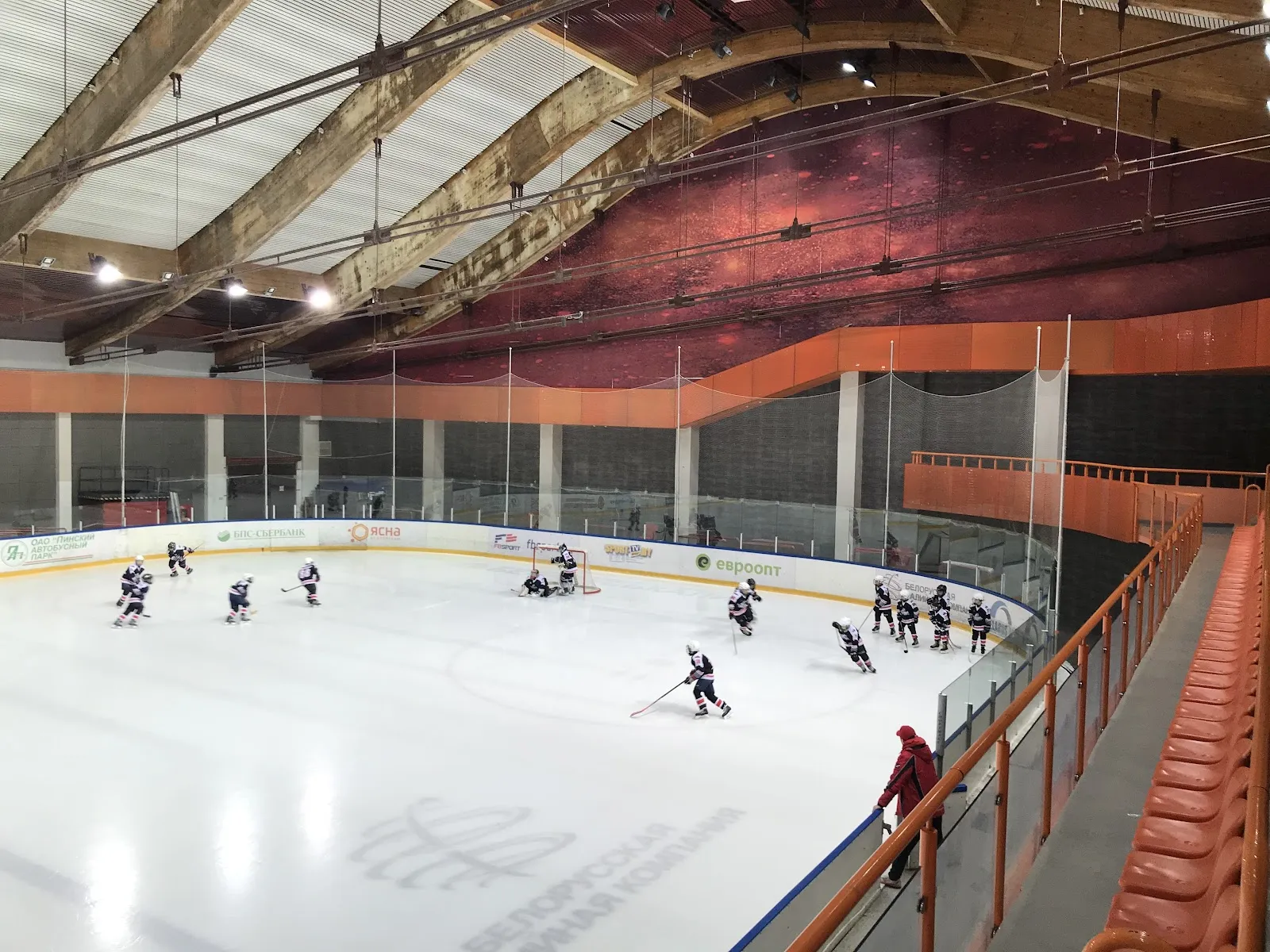 The ice sheet and orange stands of the PolesGU ice arena in Pinsk — PolesGU Ice Arena