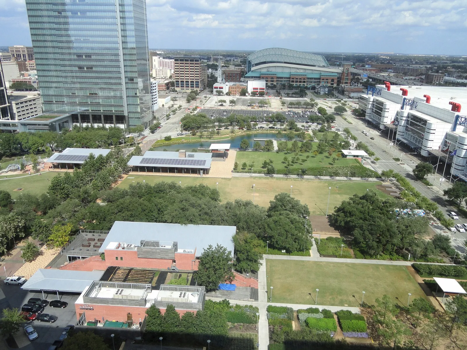 Aerial view of Discovery Green in downtown Houston; Kinder Lake, whose model boat basin becomes the ice rink each winter, is at the top centre — Ice at Discovery Green