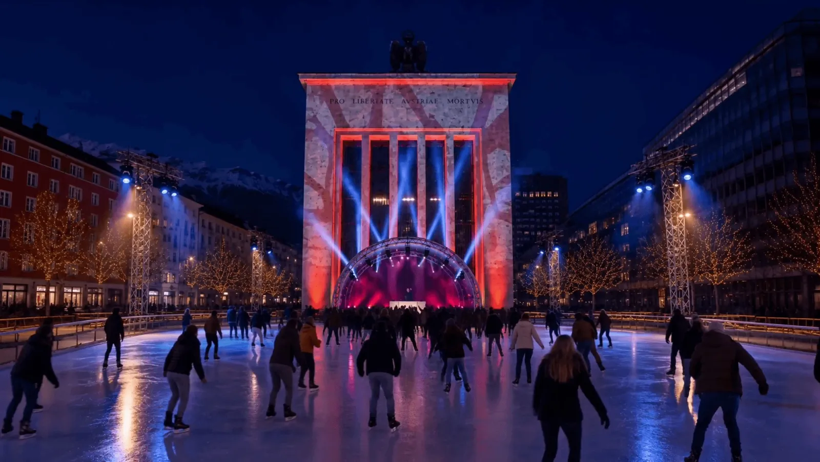 The Ice Magic rink on Landhausplatz in Innsbruck at night, with the Landhaus gate lit in red and skaters on the ice — ICE MAGIC Innsbruck (Landhausplatz & Bozner Platz)