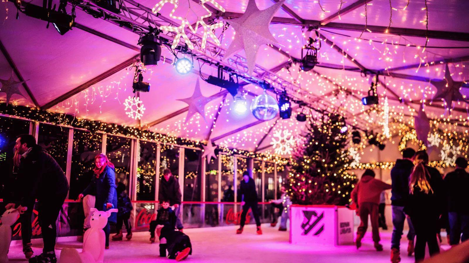 Skaters on the lit, covered IceBox rink (the operator's photo) — IceBox at BOXPARK Liverpool