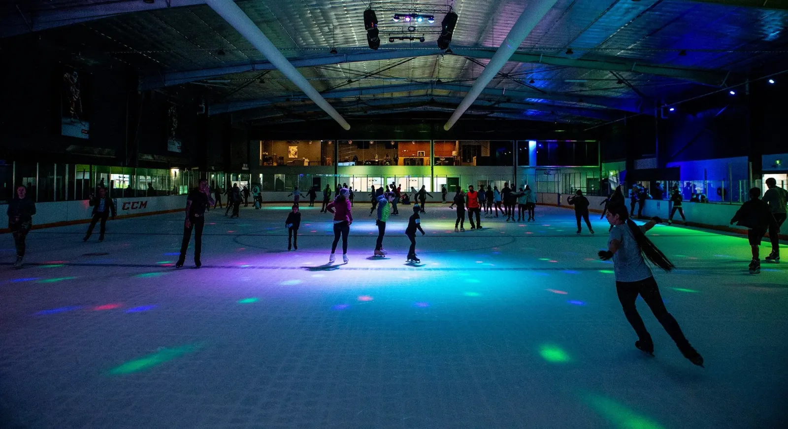 A public session under disco lighting on the ice at iceHQ — iceHQ