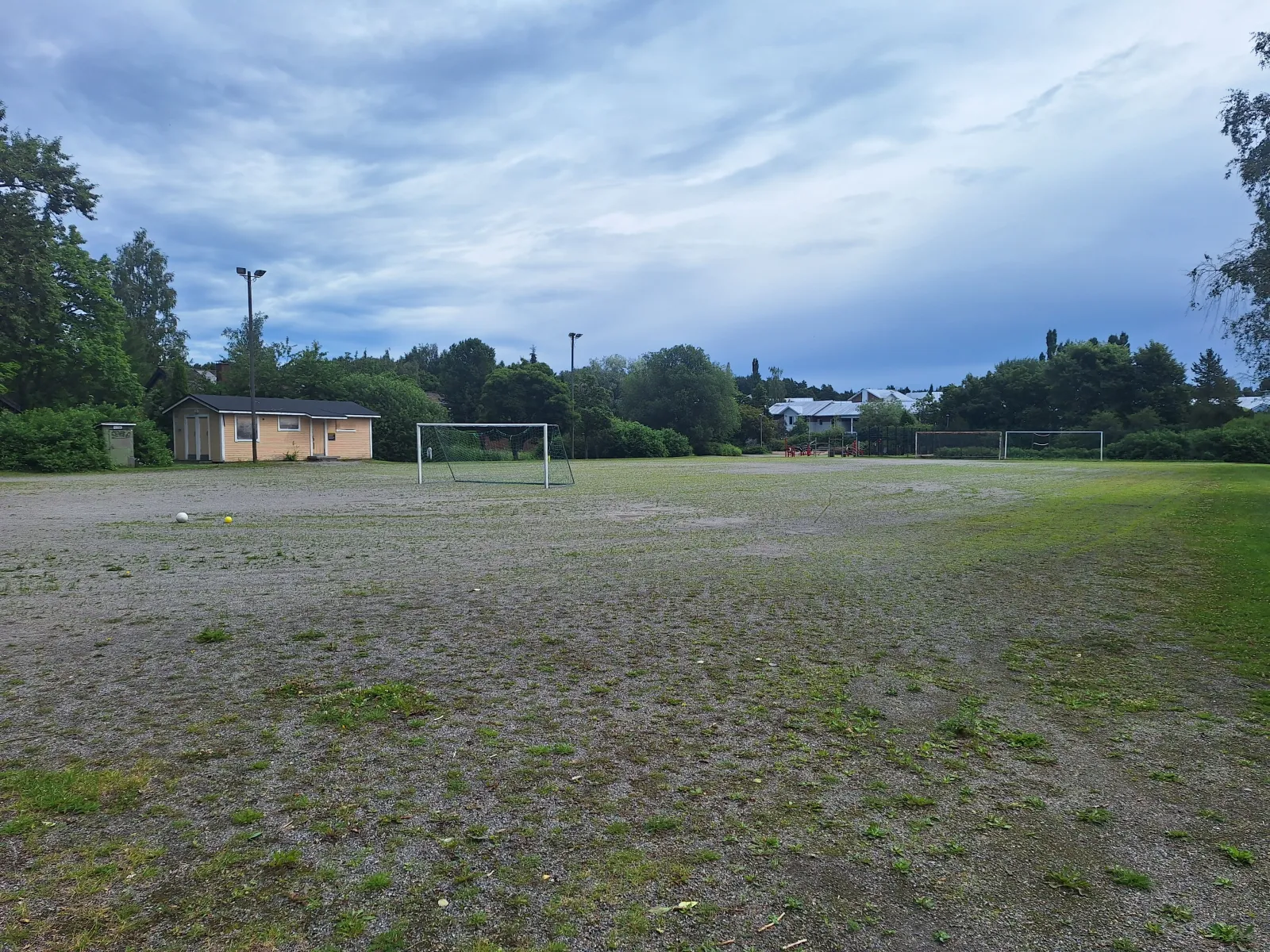 The Ingegerdin field in summer, a ball field with a gravel (stone-dust) surface with goals; the City of Turku freezes its fields into skating fields in winter. — Ingegerdin luistelukenttä