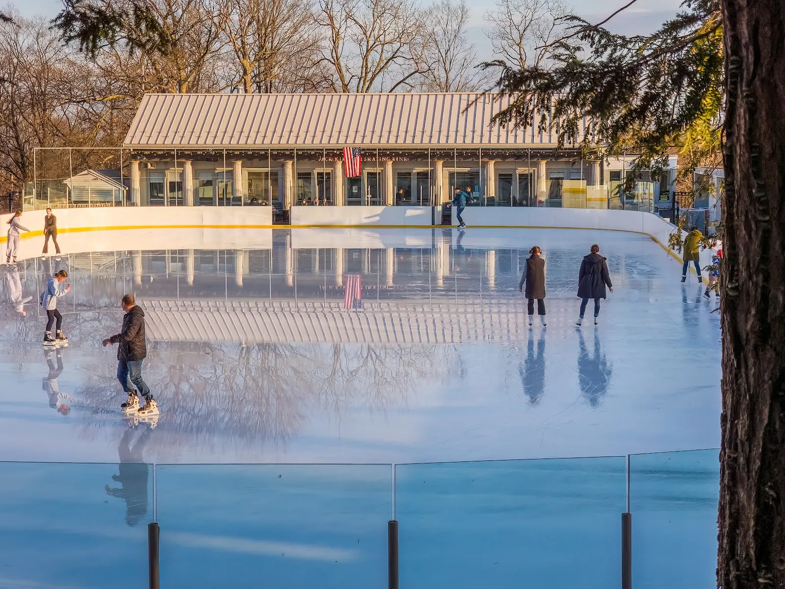 A few skaters on the open-air Jack Kirrane rink beneath the long pavilion roof at Larz Anderson Park. — Jack Kirrane Ice Skating Rink