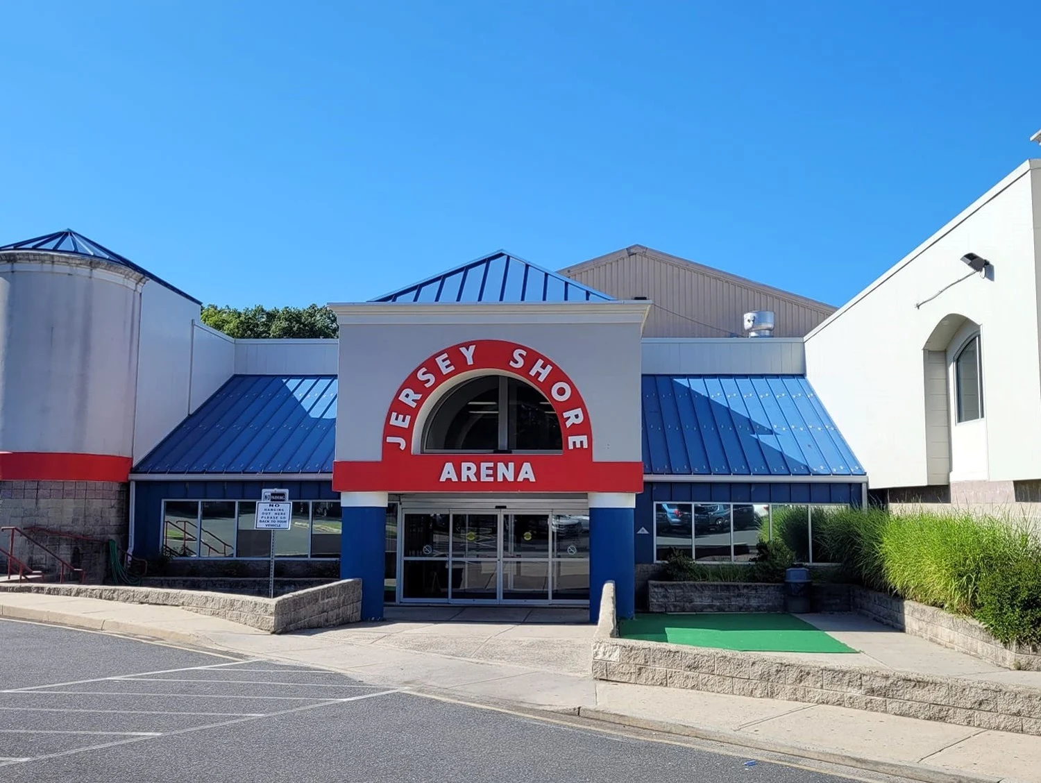 Jersey Shore Arena's main entrance beneath its red-and-blue arch and arena lettering. — Jersey Shore Arena