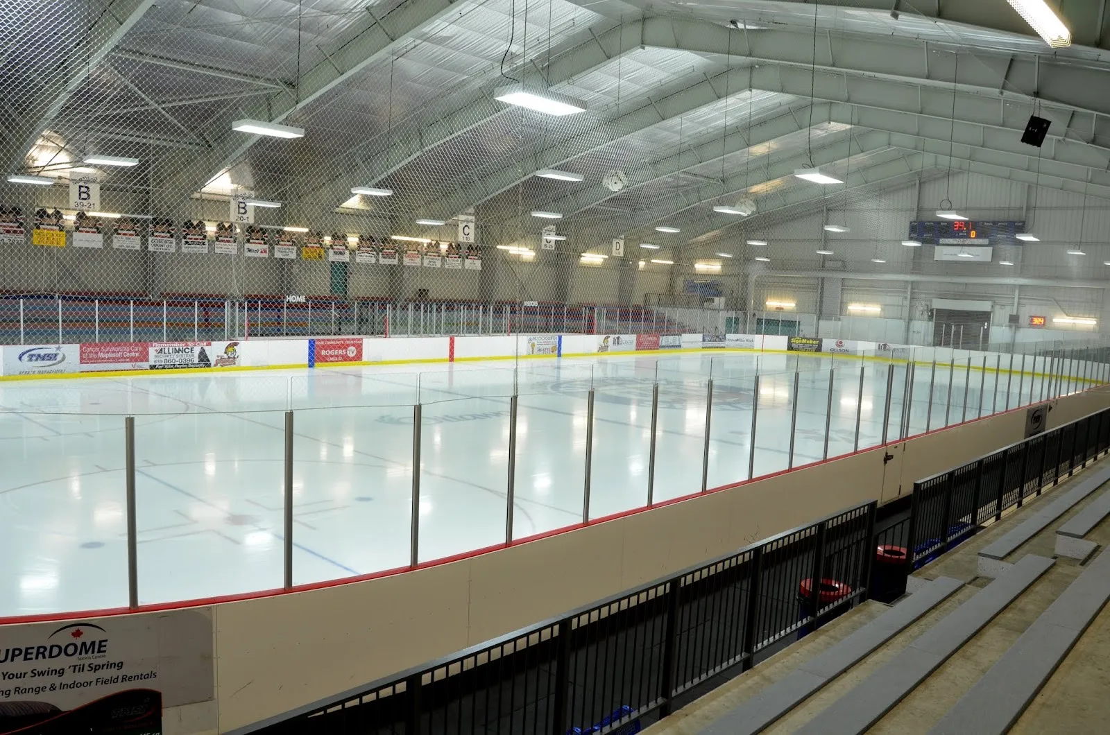 An empty ice pad at the Jim Durrell Recreation Centre in Ottawa, seen from the stands along the glass — Jim Durrell Recreation Centre