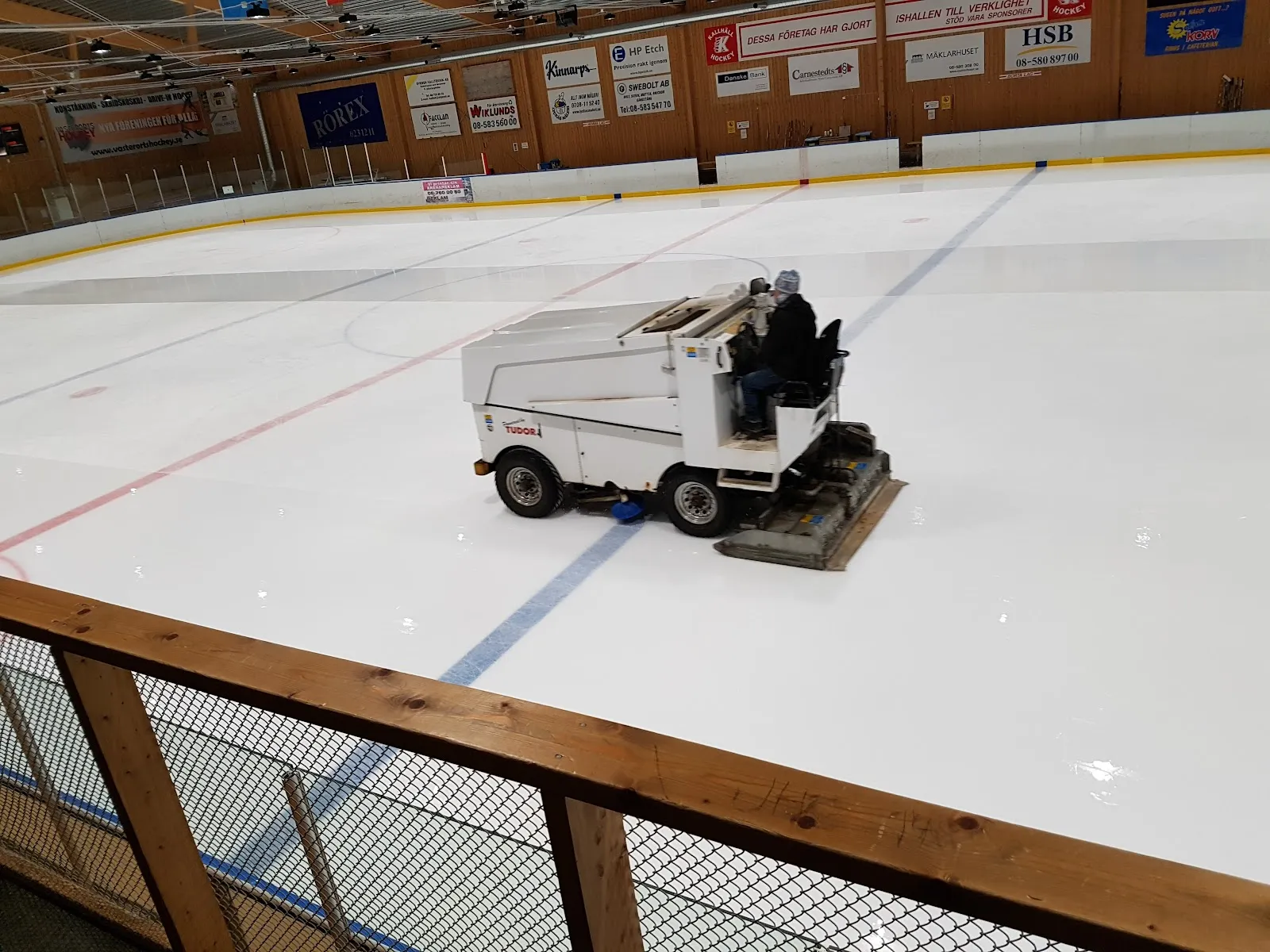 The ice sheet at Kallhälls ishall with the ice resurfacer at work — Kallhälls ishall