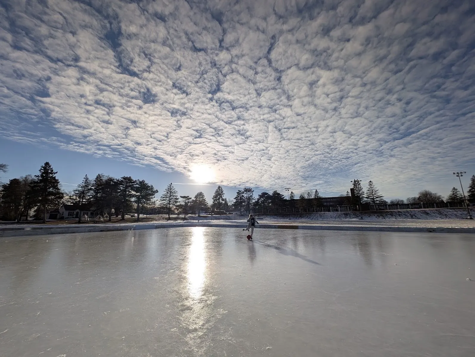 Skater on the frozen rink at Kenny Park, Minneapolis (Google Maps listing photo) — Kenny Park Outdoor Rink