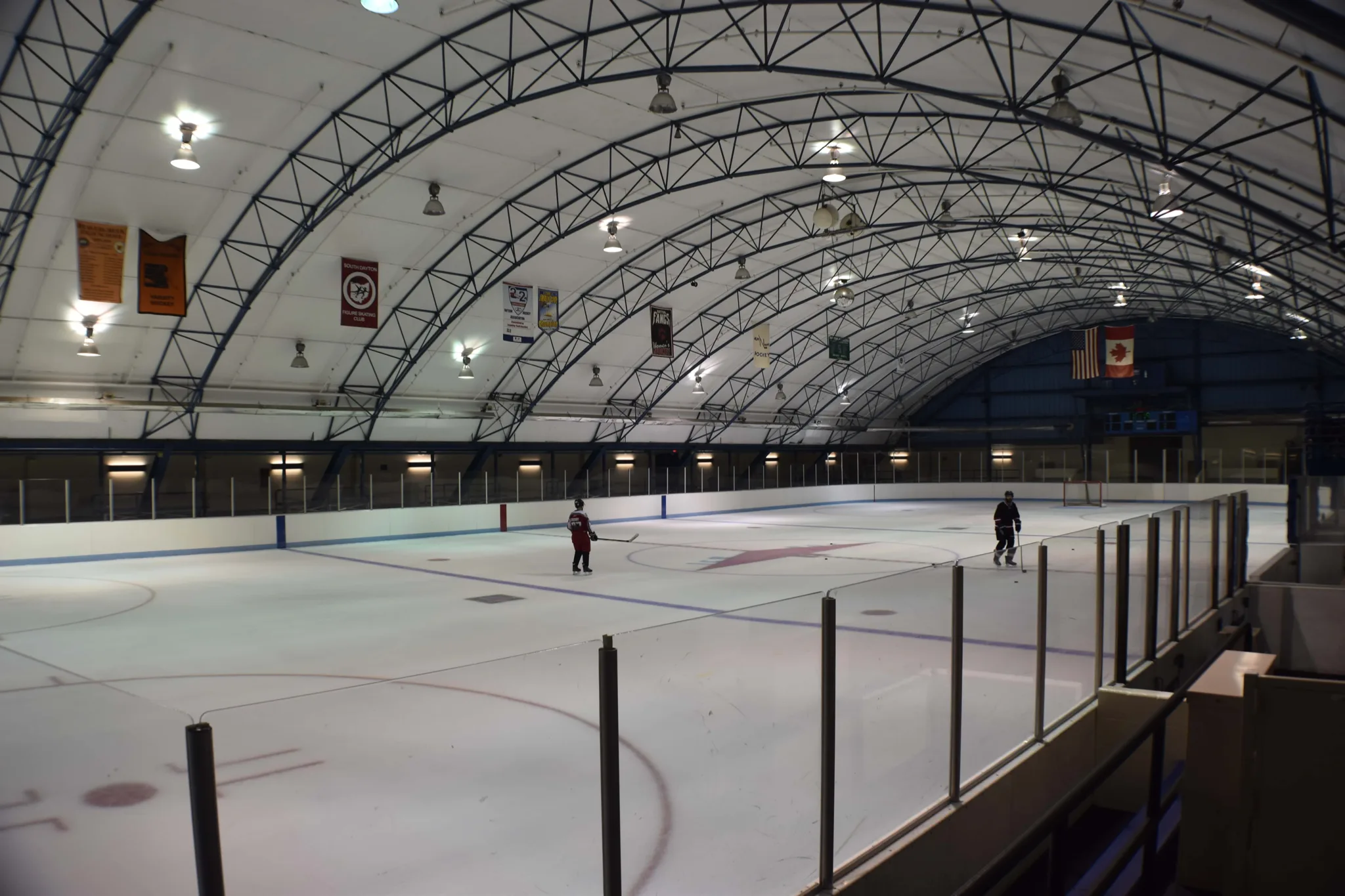 Whole ice sheet seen from the corner glass with only two skaters out — Kettering Ice Arena