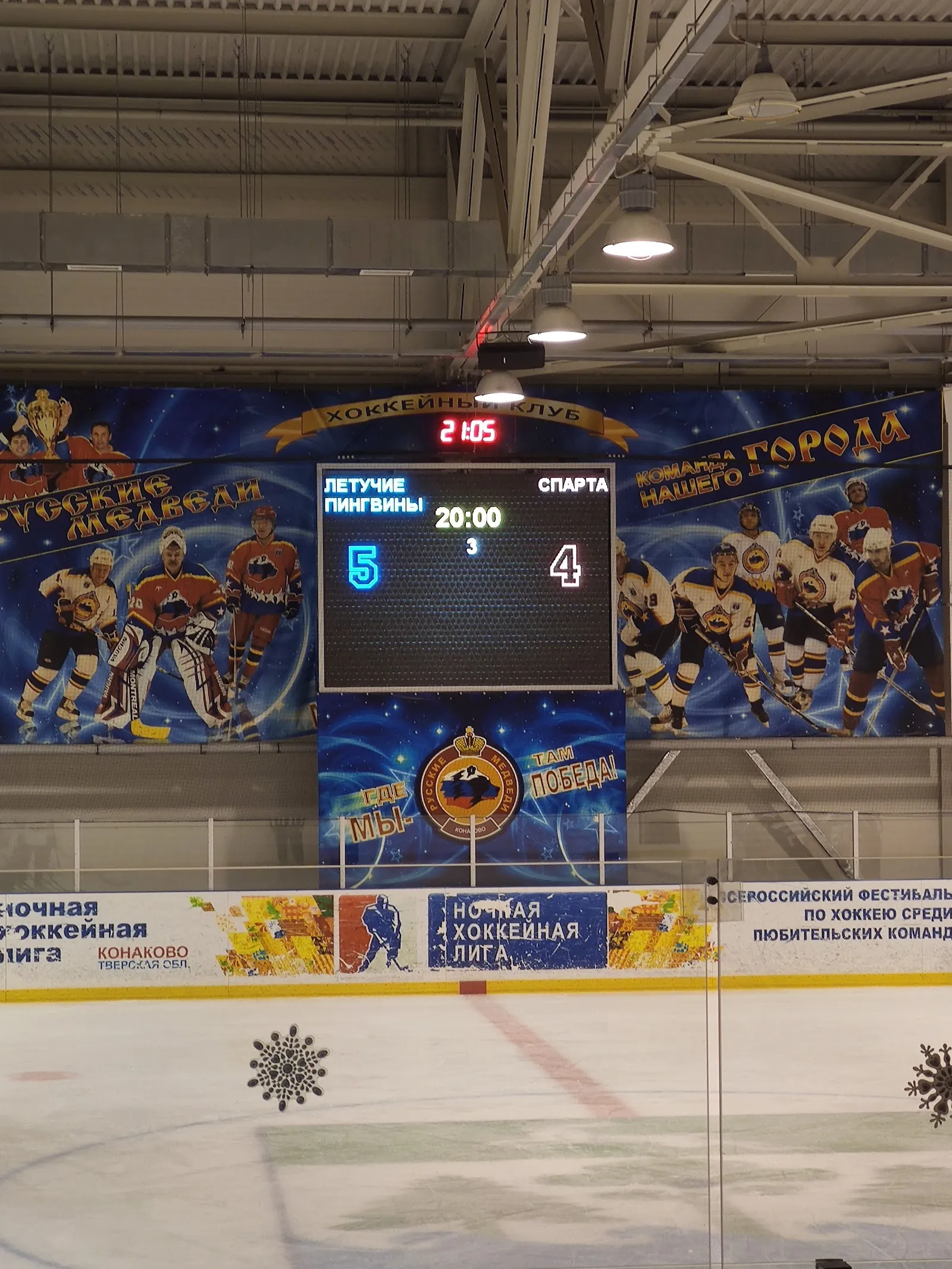 The scoreboard and club banners above the boards of the Konakovsky Led ice sheet — Konakovsky Led Ice Arena