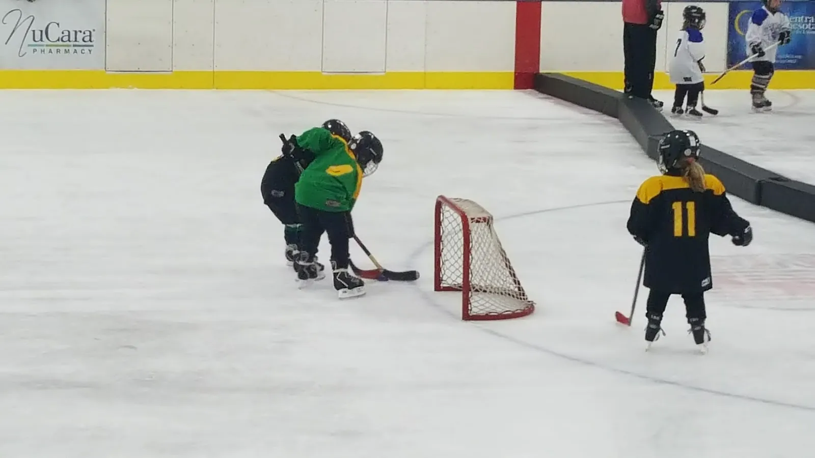 Young skaters playing a small-area hockey game on the arena ice — Koronis Civic Arena