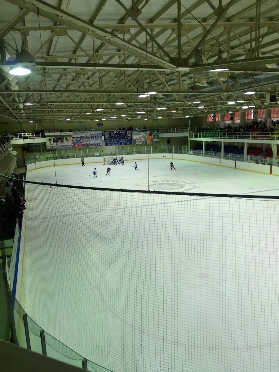 The ice and boards inside the Kristall sports palace in Gubkin, seen from the side of the rink. — Kristall Sports Palace
