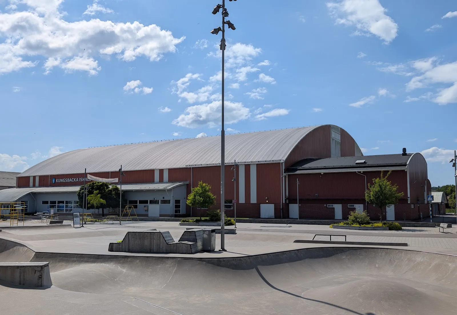 The arched brick hall of Kungsbacka ishall seen from the skatepark — Kungsbacka ishall