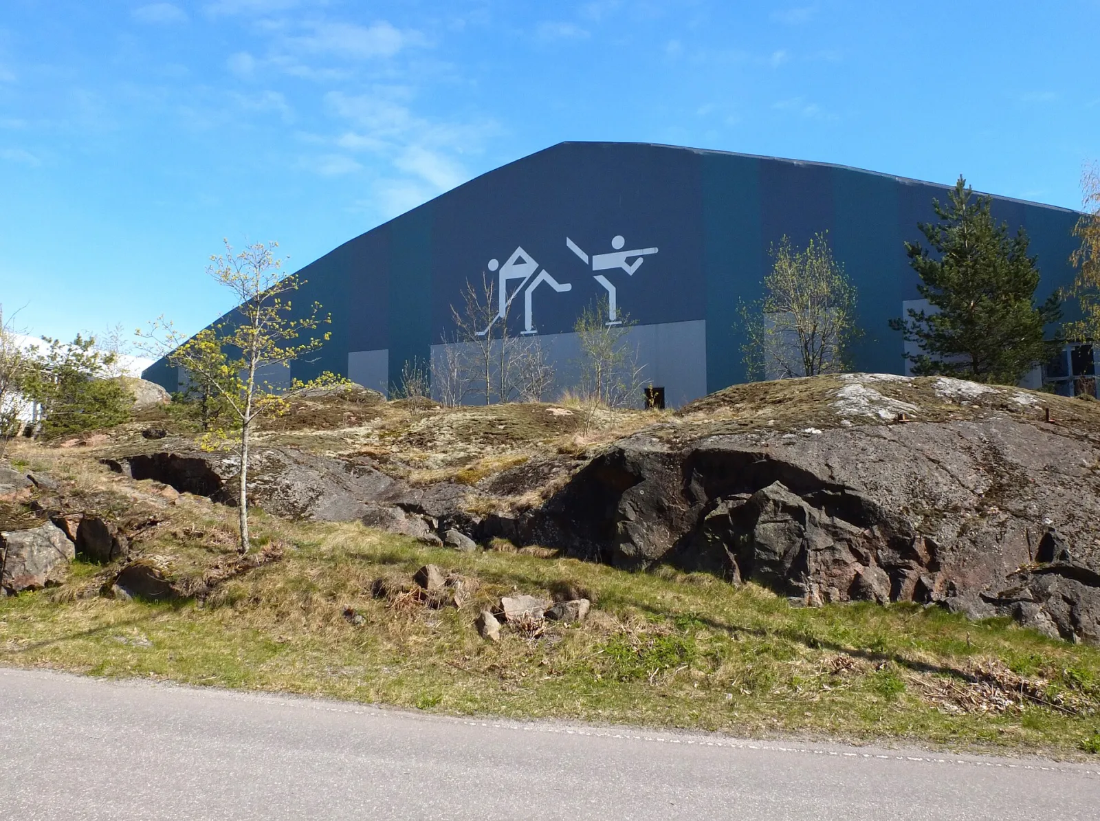 Ice hall at the Kuparivuori sports centre in Naantali, with skating pictograms on the wall (Commons title: Kuparivuori bigger indoor skating rink) — Kuparivuorihalli