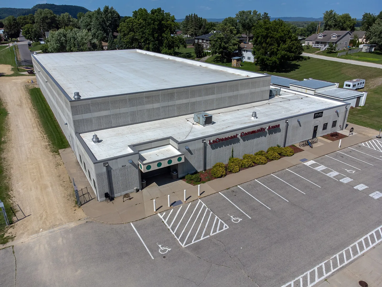 Aerial view of the La Crescent Community Arena in La Crescent, Minnesota, with its entrance and car park on the near side. — La Crescent Community Arena