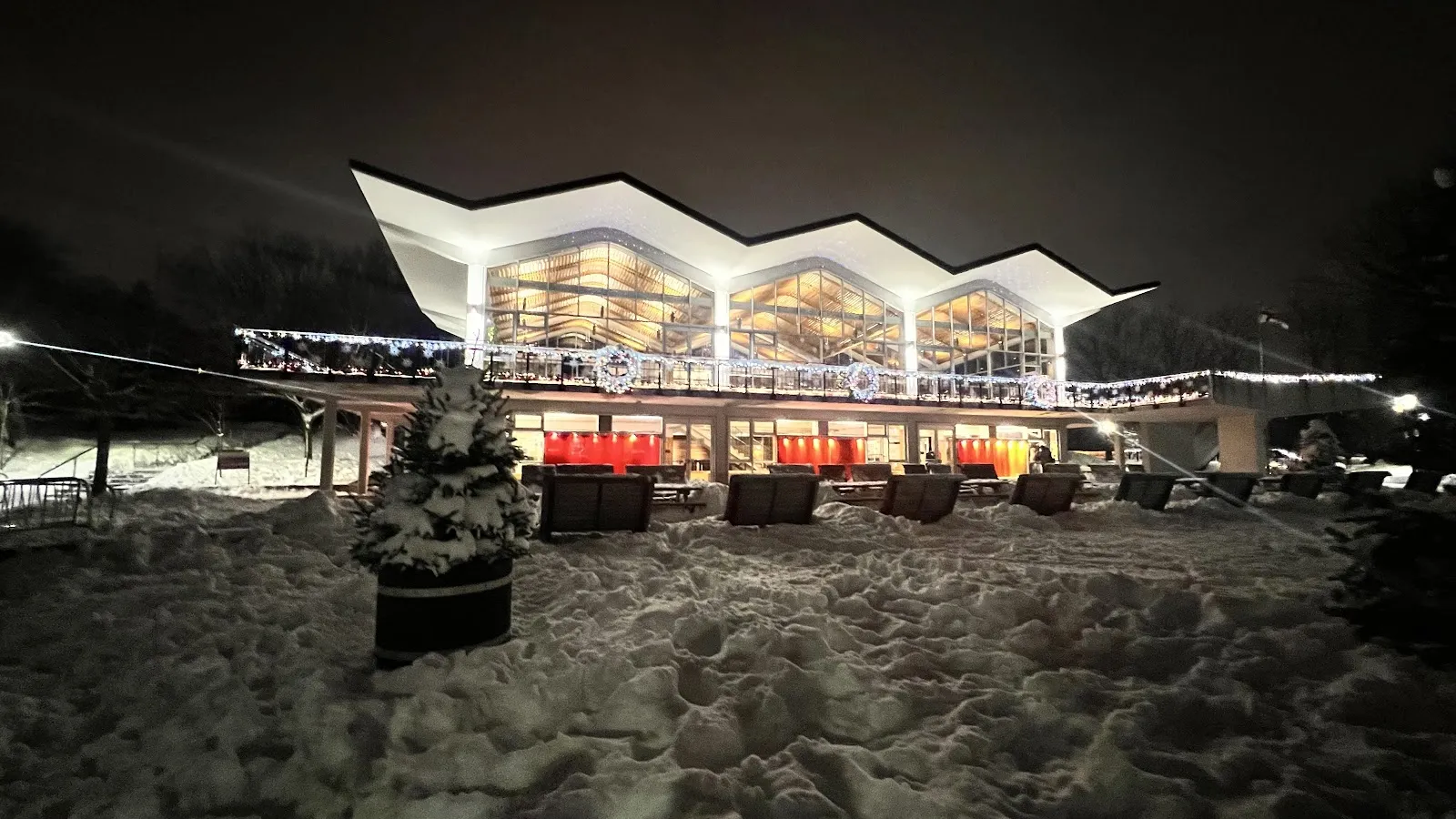 The Beaver Lake pavilion in the Mont-Royal park lit at night in winter, seen across snow, with no people in view — Lac aux Castors Rink (Parc du Mont-Royal)