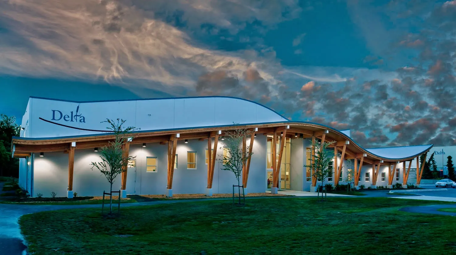 Ladner Leisure Centre, 4600 Clarence Taylor Crescent, Delta: the building with its wooden canopy at dusk — Ladner Leisure Centre