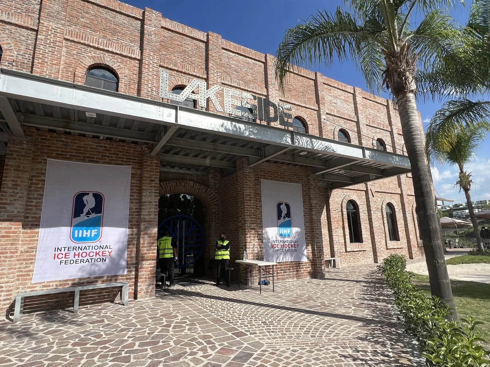 The brick Lakeside building with its LAKESIDE letters over the entrance, hung with IIHF banners for a tournament — Lakeside Ice Park