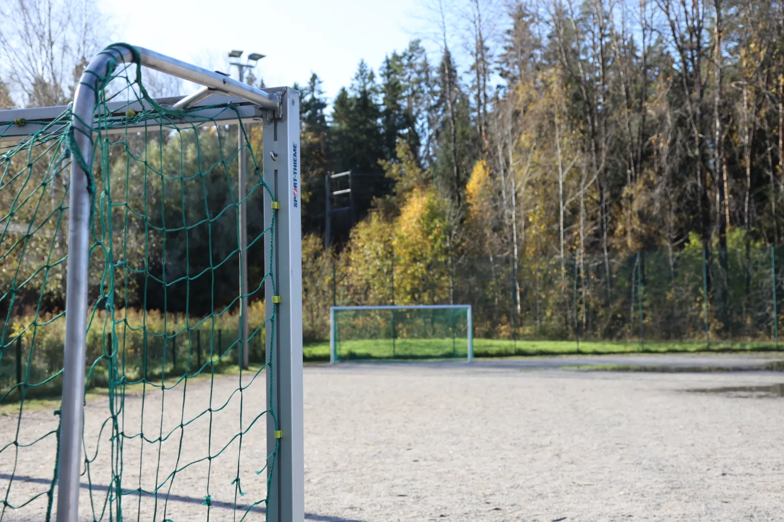 The Lausteen field in summer, a ball field with a gravel (stone-dust) surface with goals; the City of Turku freezes its fields into skating fields in winter. — Lausteen luistelukenttä