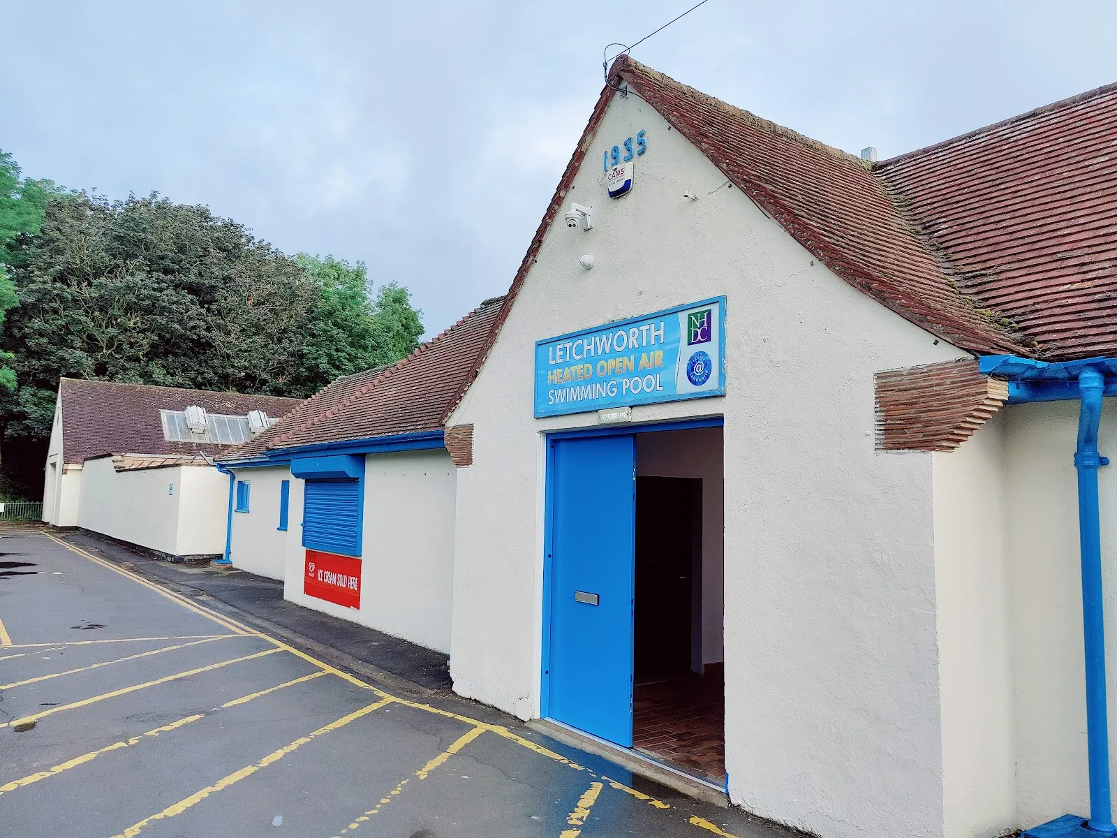 The white 1955 pool building and entrance of Letchworth Lido, where the winter ice rink is set up — Letchworth Lido Ice Rink