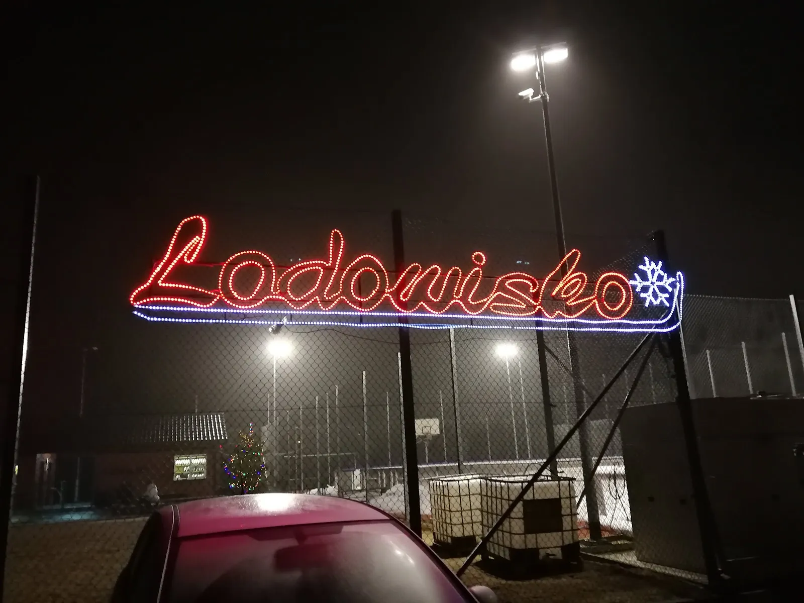 The Lodowisko neon sign and floodlights over the Grajewo rink at night, 11 Listopada 5 — Lodowisko Biały Orlik Grajewo