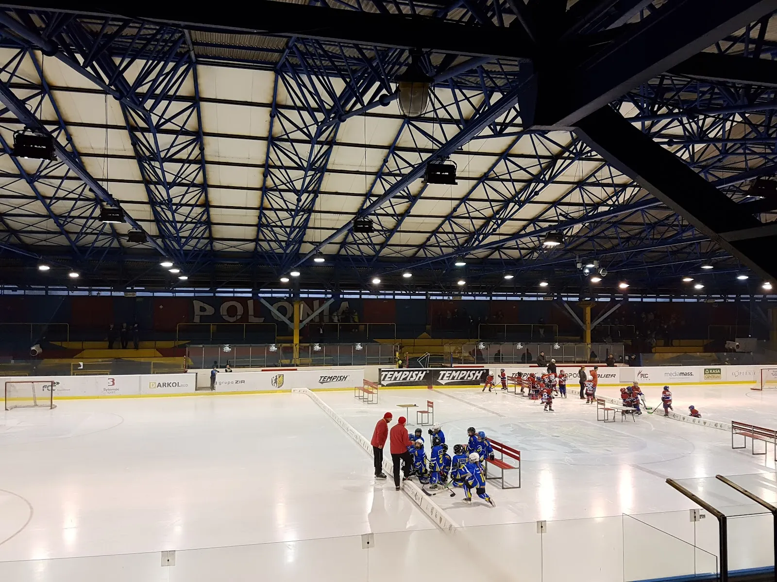 Interior of the rebuilt Bytom ice rink with the roof structure and ice surface — Lodowisko im. Braci Nikodemowiczów Bytom