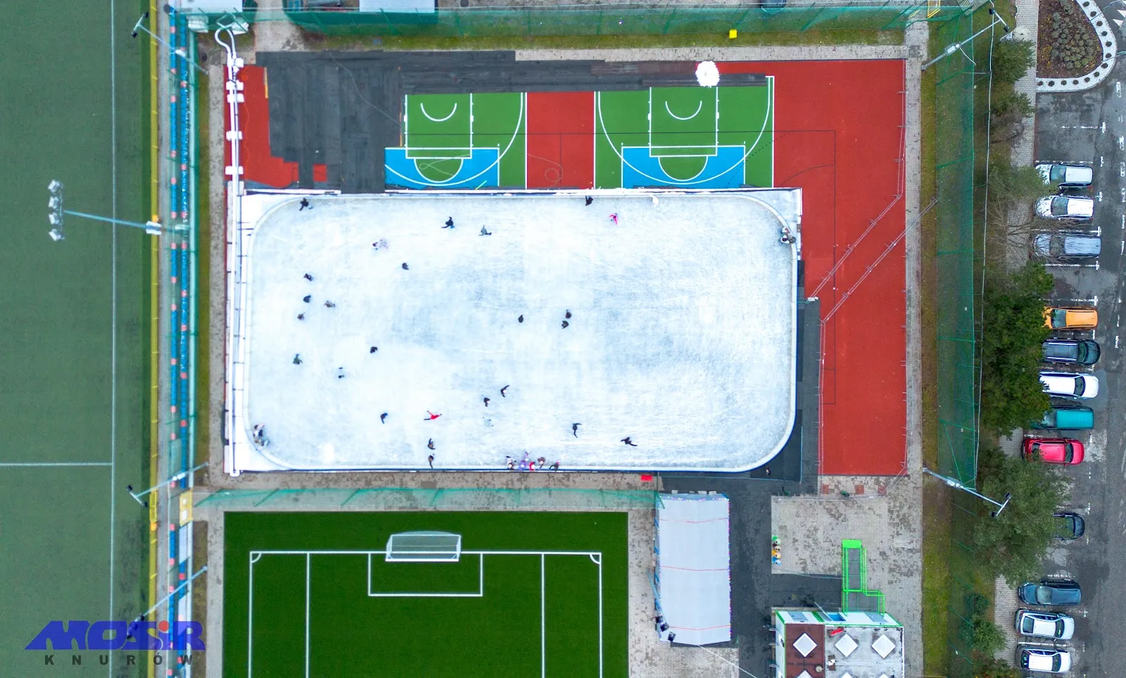 Aerial view of the Knurów seasonal ice rink beside the football pitch and courts, Ułanów 8 — Lodowisko Sezonowe MOSiR Knurów