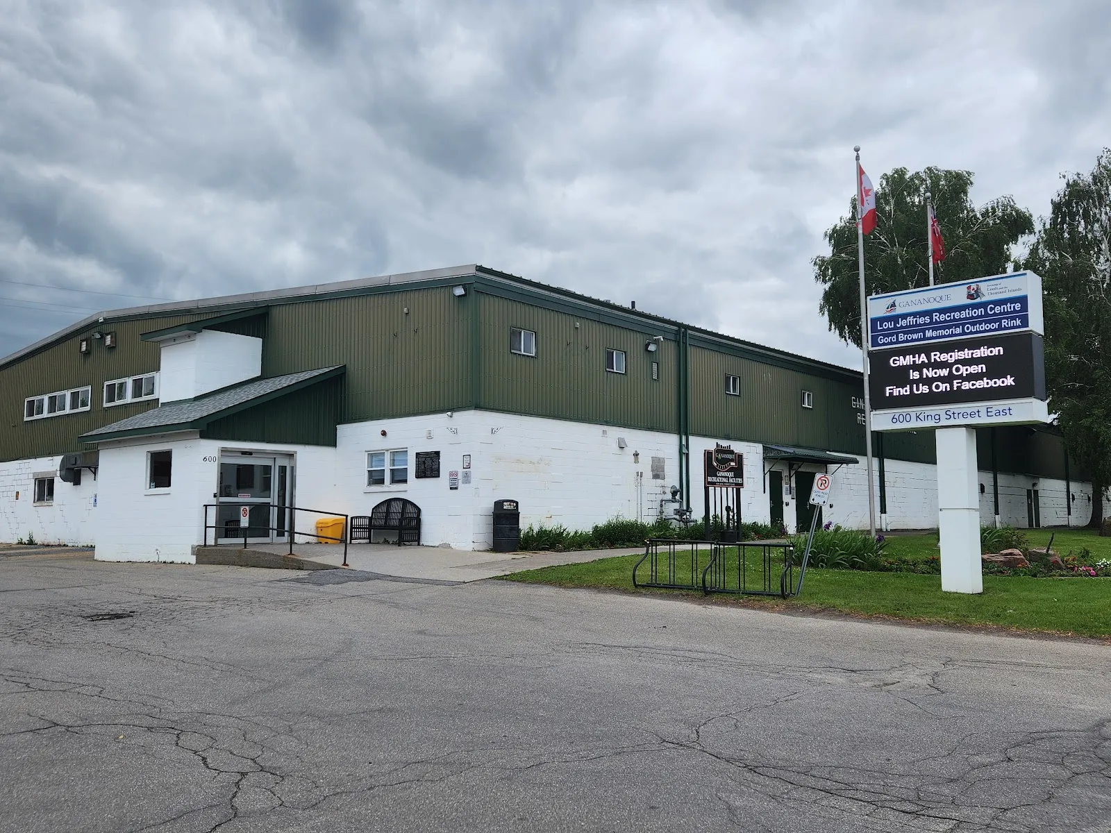The green-roofed Lou Jeffries Recreation Centre with its sign showing 600 King Street East — Lou Jeffries Arena