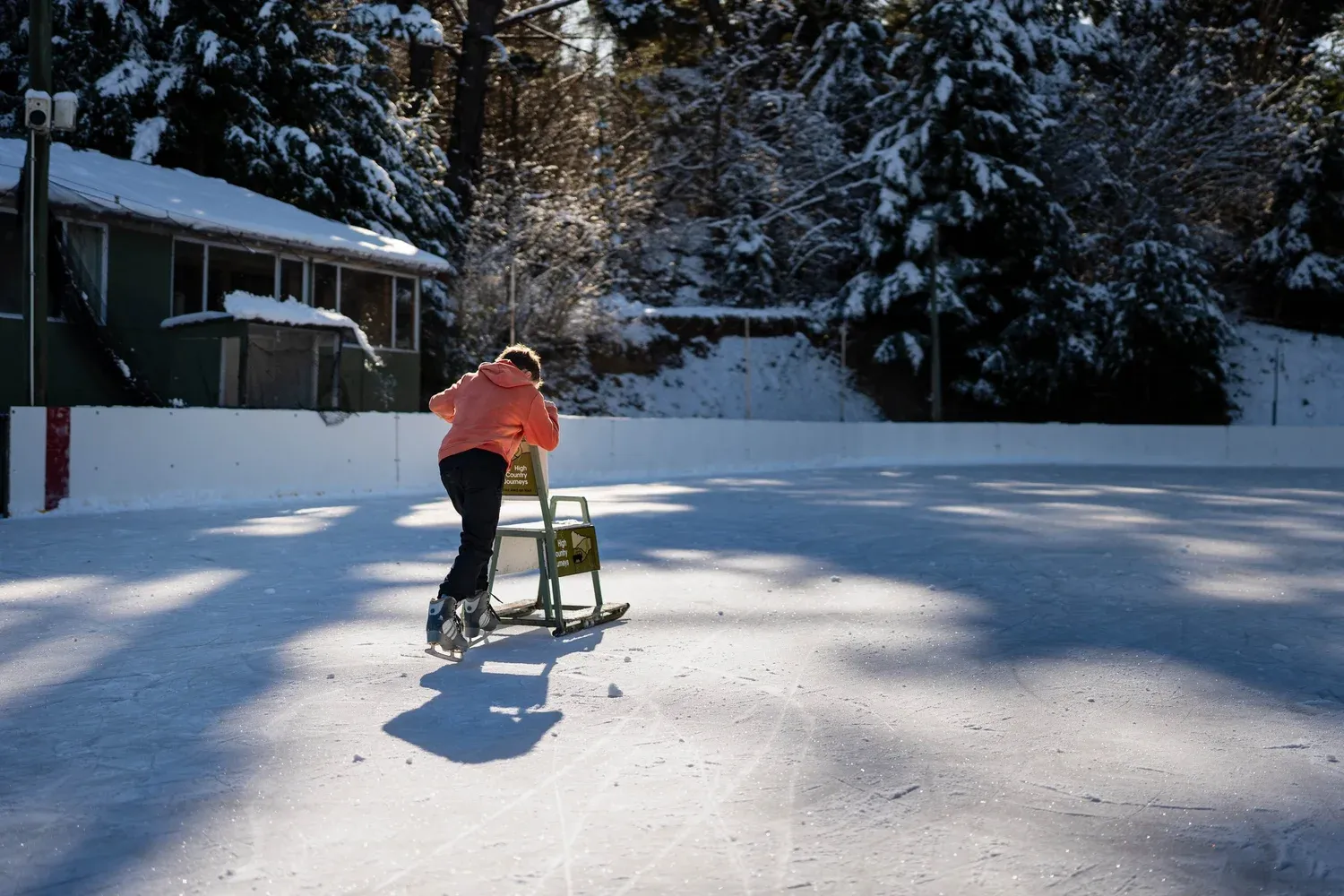 A child skating with a skating aid on the outdoor rink at Naseby — Maniototo Adventure Park