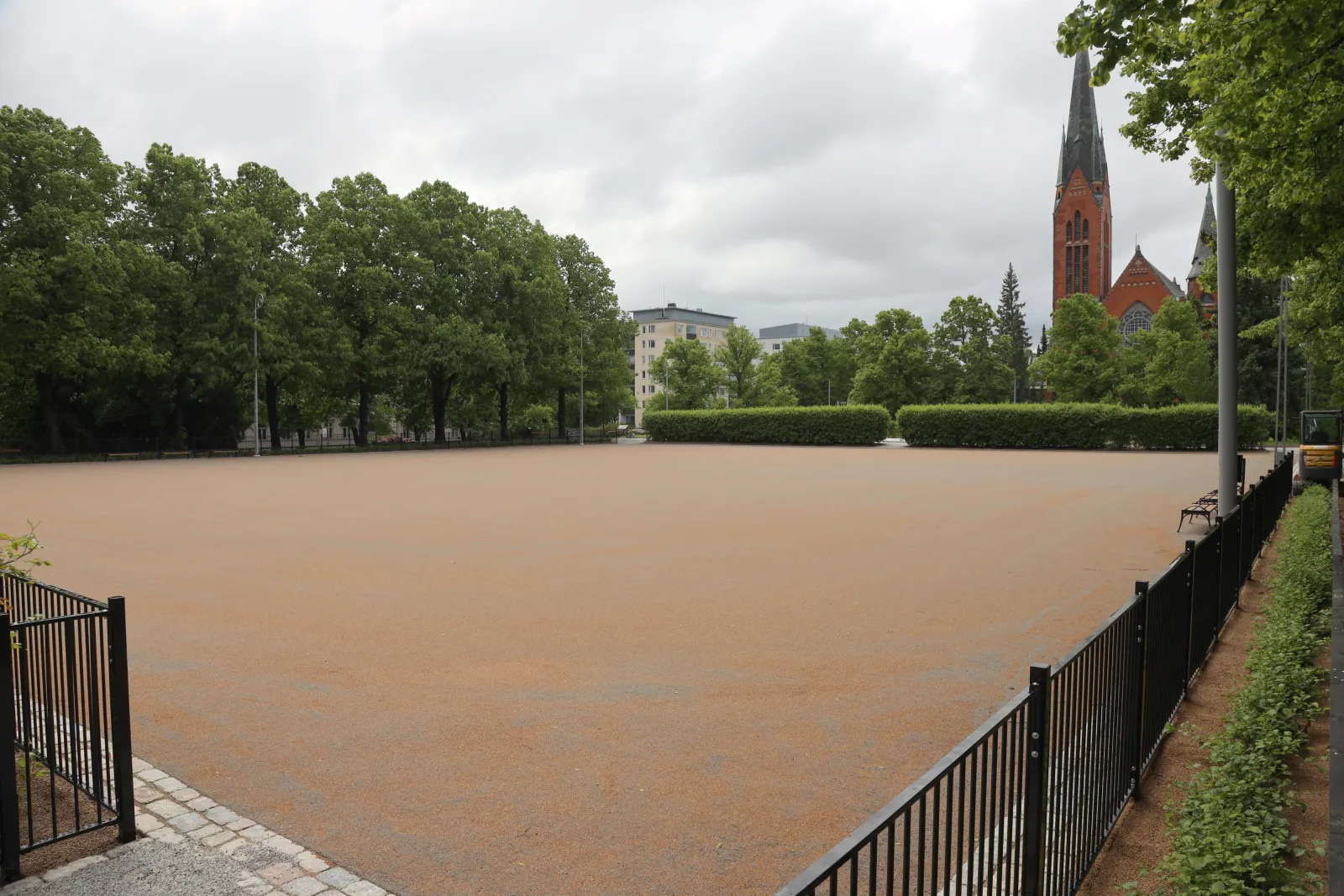 The Mannerheiminpuiston field in summer, a sand-filled artificial-turf pitch with goals; the City of Turku freezes its fields into skating fields in winter. — Mannerheiminpuiston luistelukenttä