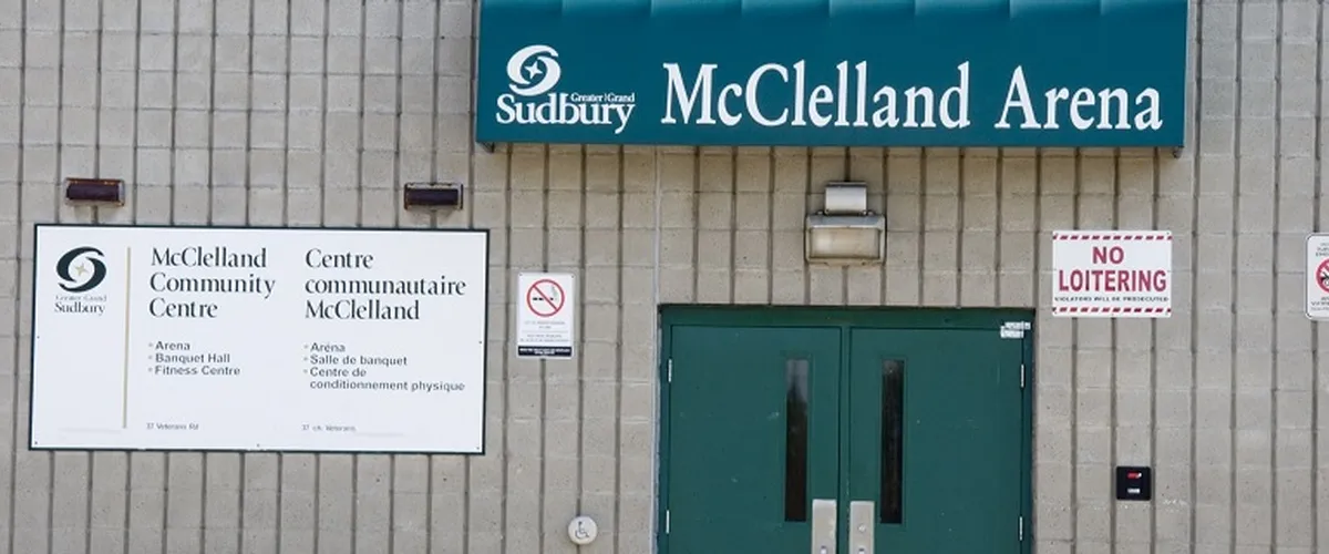 The arena doors under the green McClelland Arena sign, with the community centre’s bilingual directory. — McClelland Community Centre and Arena (Copper Cliff)
