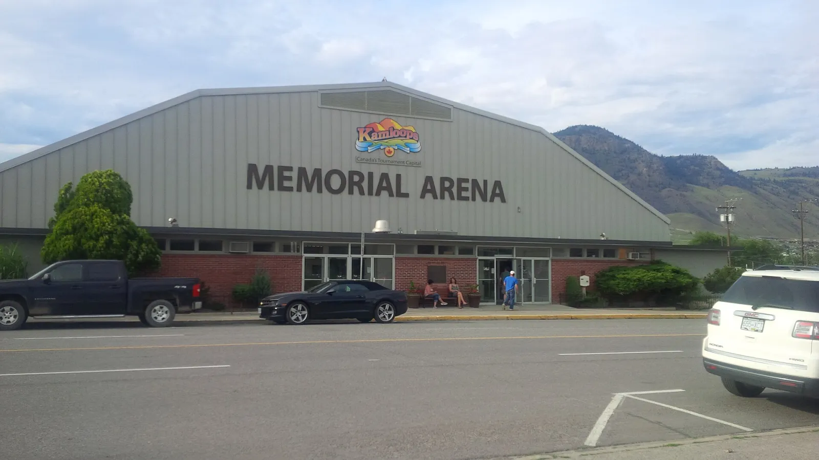 The front of Memorial Arena on Victoria Street, with its brick entry pavilion and sign. — Memorial Arena