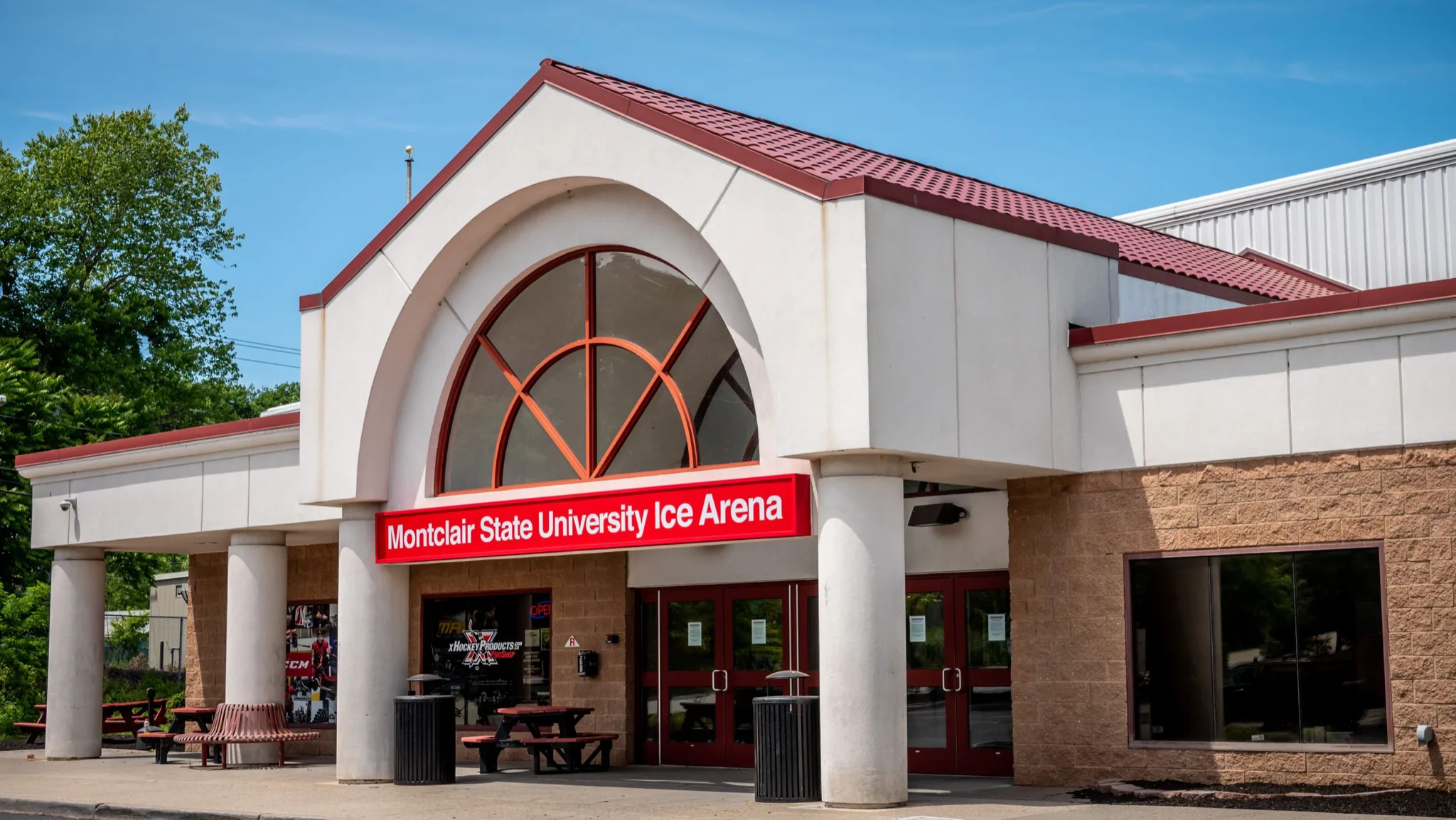 Arched main entrance of Montclair State University Ice Arena on a clear, sunny day — Montclair State Arena