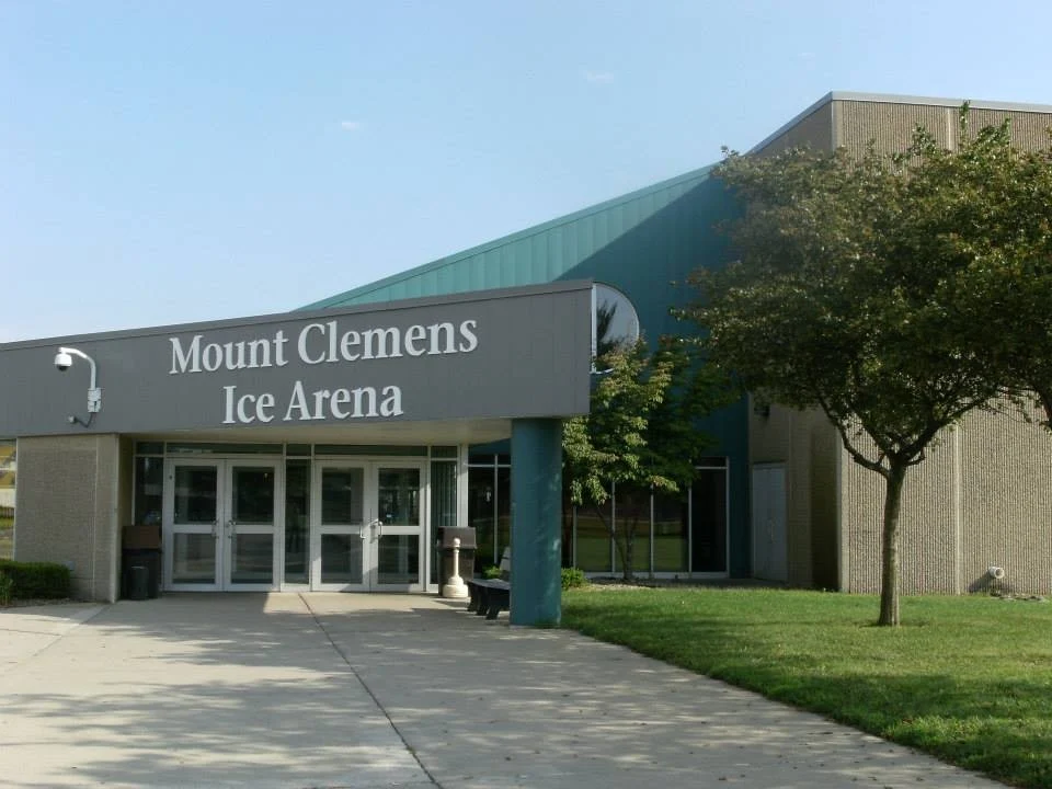 Mount Clemens Ice Arena's main doors beneath its green, lettered entrance canopy. — Mount Clemens Ice Arena
