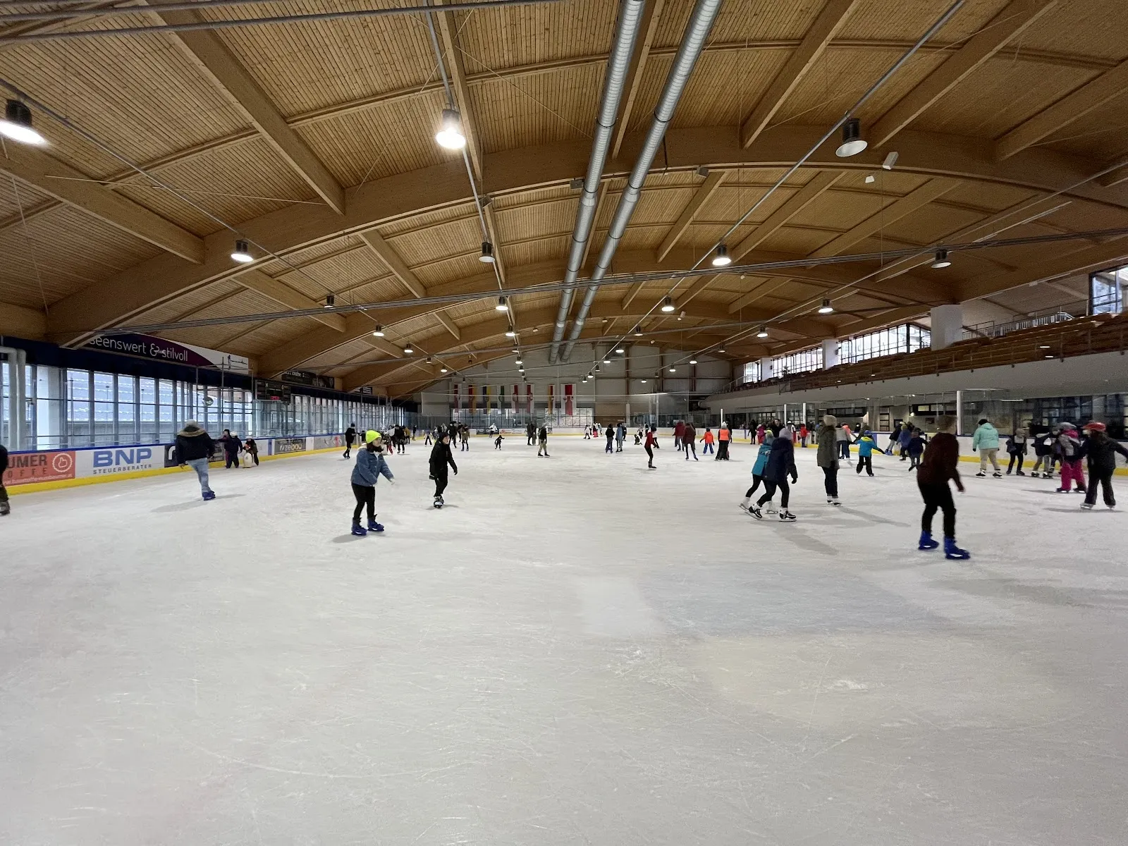 Interior of the ice hall with skaters at a distance, the rink in full view (Google Maps listing photo, Eishalle Gmunden) — Muki-Eisarena Gmunden
