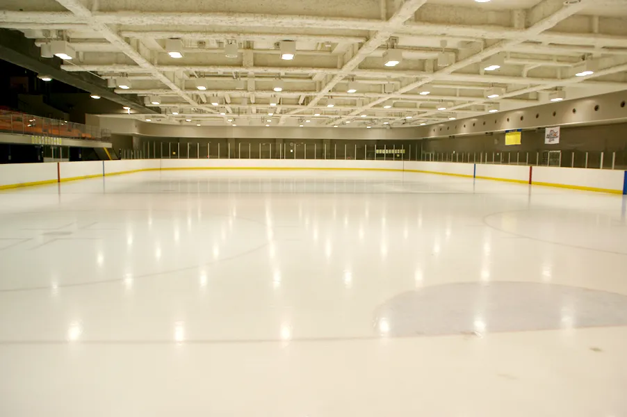 The empty ice sheet of the Naniwa Ice Skating Rink with its boards and stands — Naniwa Ice Skating Rink (Naniwa Sports Center)