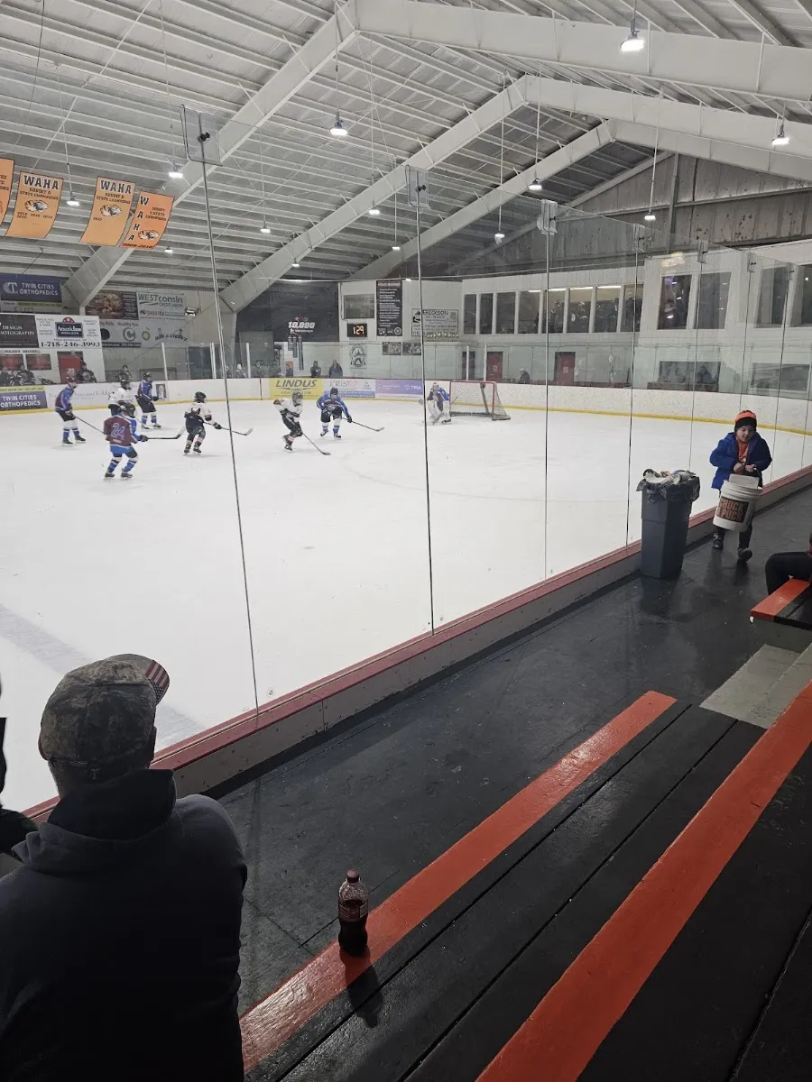A youth hockey game on the indoor ice at New Richmond Sports Center seen from the stands — New Richmond Hockey Center