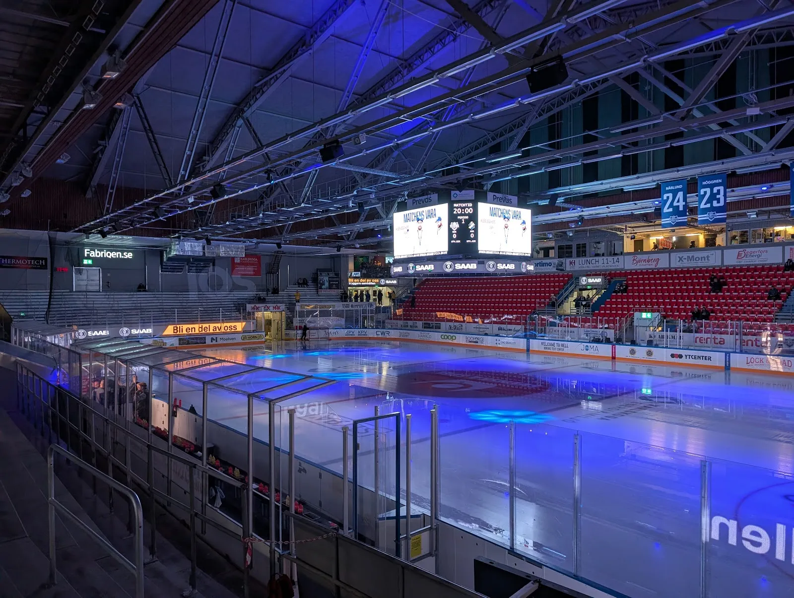 The empty ice and stands of Nobelhallen lit in blue before a game — Nobelhallen
